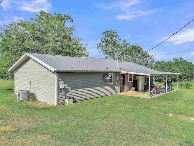 3738 Fm 161 S, Hughes Springs, TX 75656 - rear view of house with a patio, a yard, and a metal roof