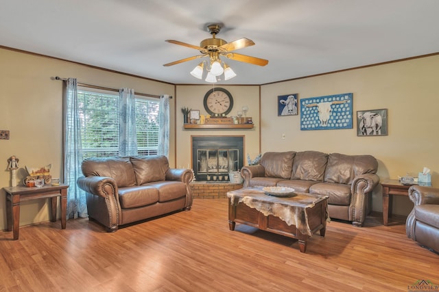 3738 Fm 161 S, Hughes Springs, TX 75656 - living room featuring light wood-type flooring, ceiling fan, crown molding, and a brick fireplace