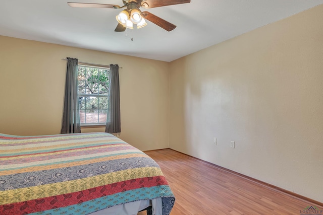 3738 Fm 161 S, Hughes Springs, TX 75656 - bedroom featuring light wood finished floors and a ceiling fan