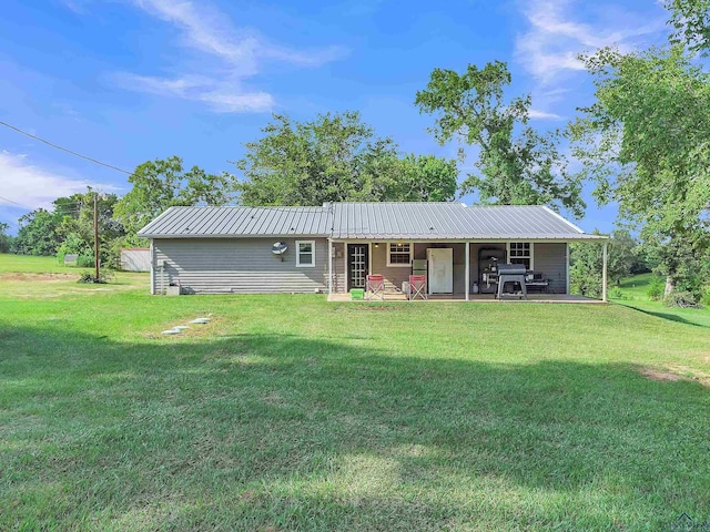 3738 Fm 161 S, Hughes Springs, TX 75656 - view of front of house featuring a front yard, a patio, and a metal roof