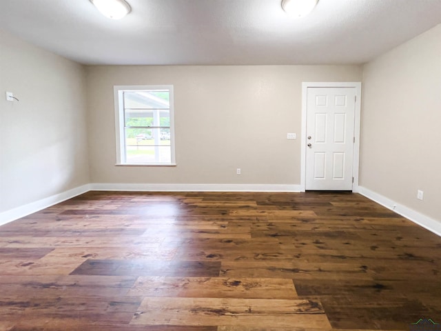 empty room featuring dark wood-type flooring