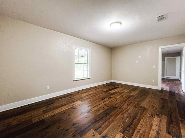 spare room with dark hardwood / wood-style floors