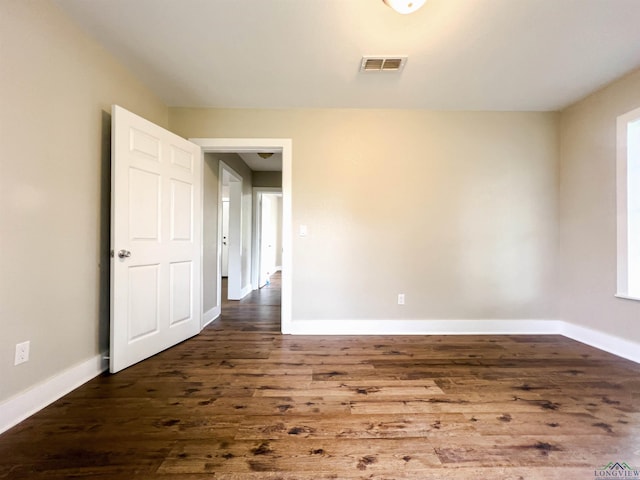 unfurnished room featuring dark hardwood / wood-style flooring