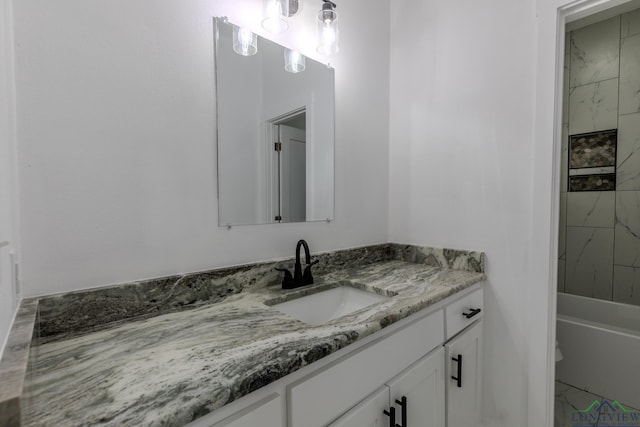 full bathroom featuring vanity, tiled shower / bath combo, and toilet