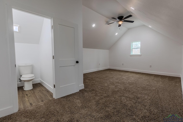 additional living space with vaulted ceiling, carpet flooring, and ceiling fan