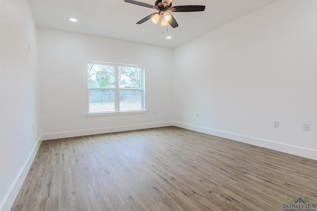 empty room featuring ceiling fan and light hardwood / wood-style floors