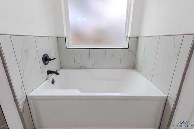 bathroom with a tub to relax in