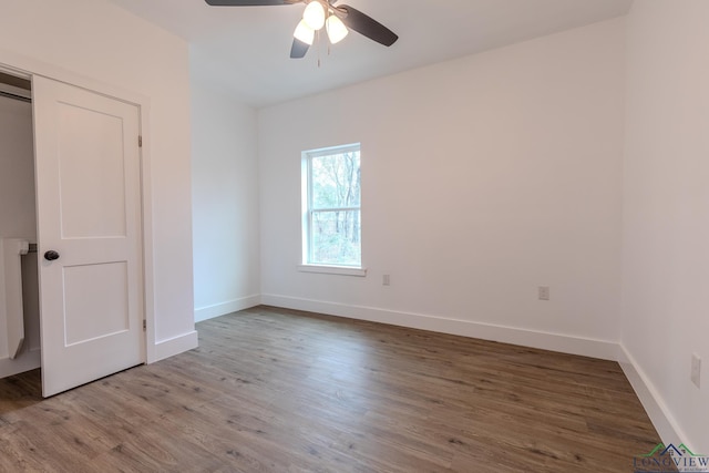 unfurnished bedroom with ceiling fan and wood-type flooring