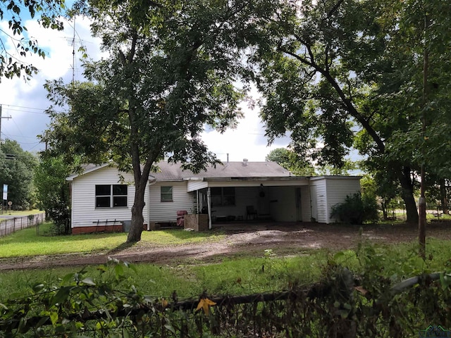 rear view of property with a yard