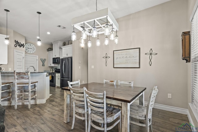 dining room with dark hardwood / wood-style flooring