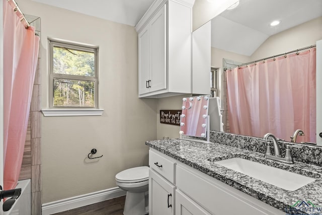 full bathroom featuring shower / bath combo, vanity, vaulted ceiling, wood-type flooring, and toilet