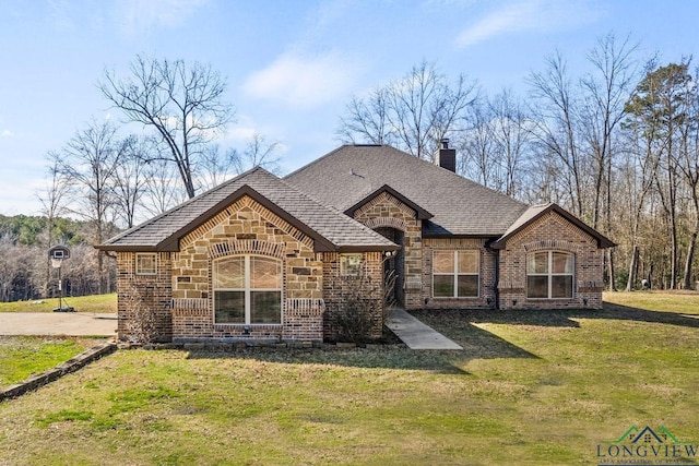 french provincial home with a front lawn