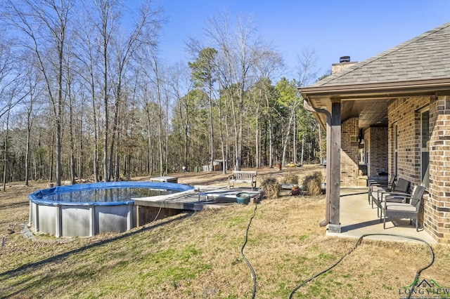 view of yard featuring a patio and a covered pool