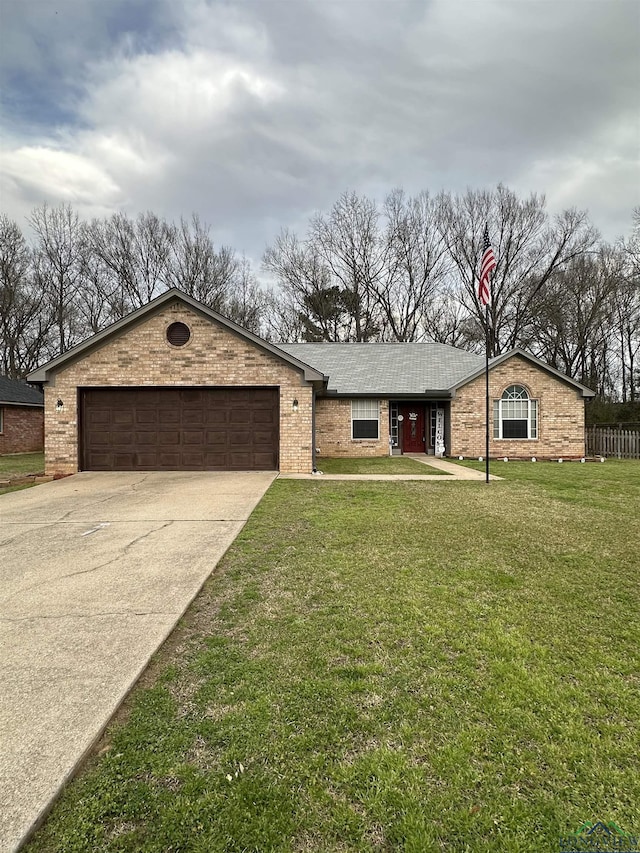 view of front of house with a front lawn, concrete driveway, brick siding, and an attached garage