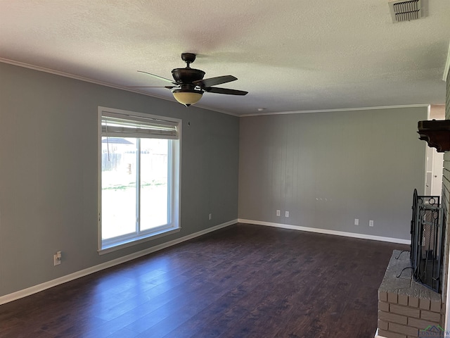 unfurnished living room with a ceiling fan, visible vents, dark wood finished floors, a fireplace, and crown molding