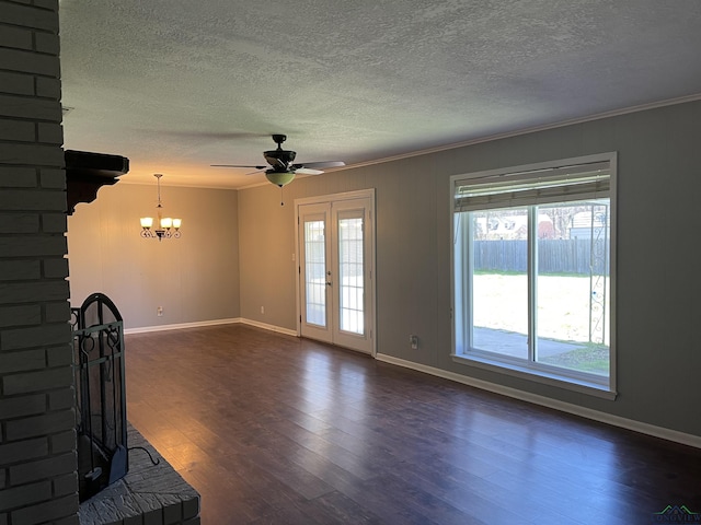 unfurnished living room with crown molding, dark wood-style floors, baseboards, and a wealth of natural light