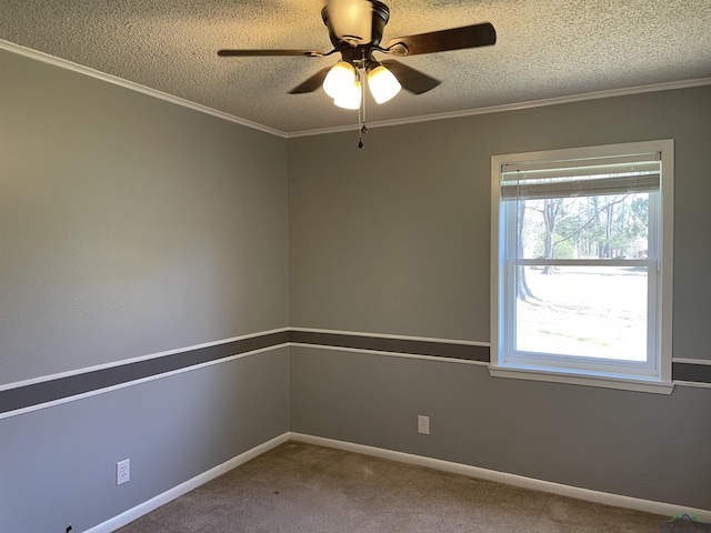 carpeted spare room featuring ceiling fan, crown molding, baseboards, and a textured ceiling