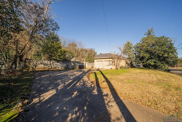 ranch-style house with a garage and a front lawn