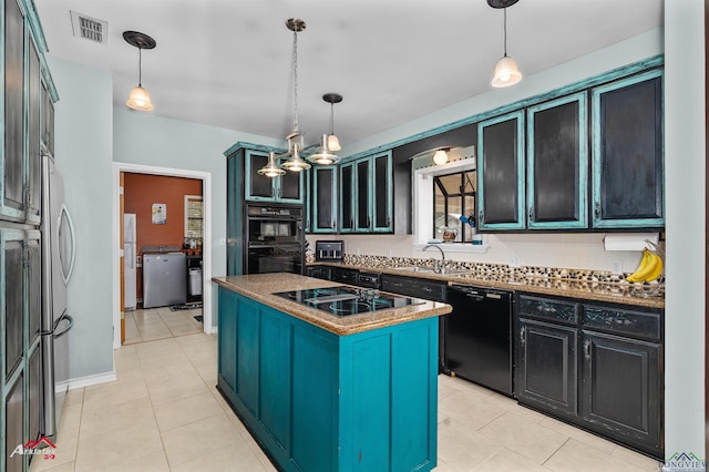 1463 County Road 106, Carthage, TX 75633 - kitchen with black appliances, a center island, decorative backsplash, light tile patterned floors, and decorative light fixtures