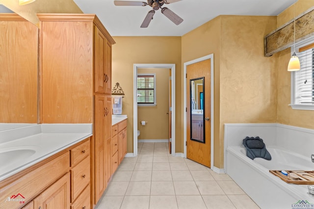 1463 County Road 106, Carthage, TX 75633 - bathroom with vanity, tile patterned flooring, a garden tub, and a ceiling fan