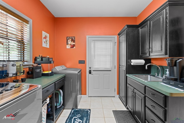 1463 County Road 106, Carthage, TX 75633 - laundry room with independent washer and dryer, light tile patterned flooring, and cabinet space