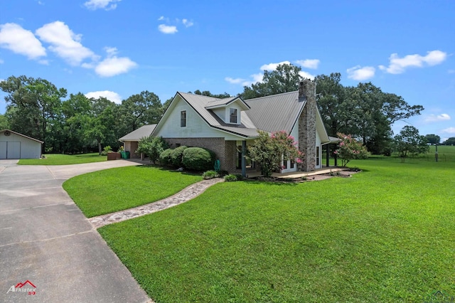 1463 County Road 106, Carthage, TX 75633 - view of front of home with a front lawn, concrete driveway, a chimney, and a garage