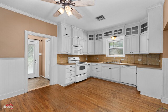 1204 Collins St, Henderson, TX 75654 - kitchen featuring white appliances, a sink, a ceiling fan, light wood-type flooring, and a wainscoted wall