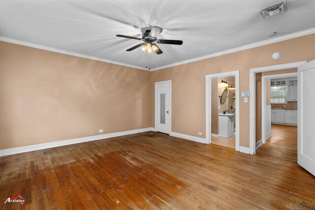 1204 Collins St, Henderson, TX 75654 - unfurnished bedroom with hardwood / wood-style floors, ornamental molding, baseboards, a sink, and ensuite bath