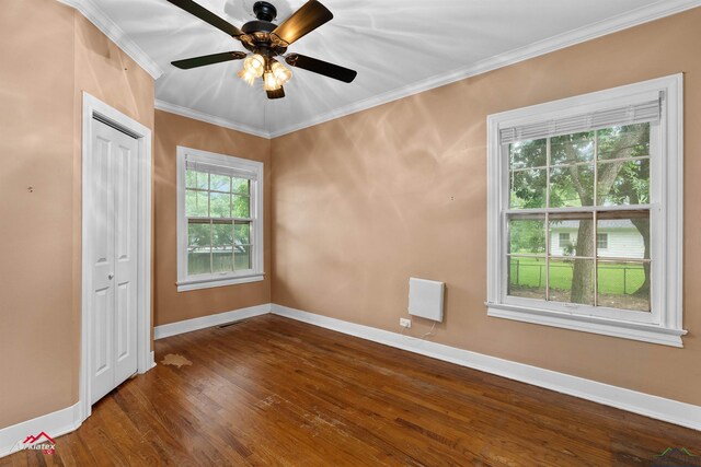 1204 Collins St, Henderson, TX 75654 - unfurnished room featuring baseboards, ornamental molding, dark wood-style flooring, and ceiling fan