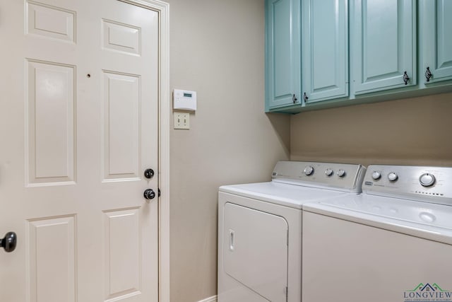 laundry room with cabinets and washing machine and clothes dryer