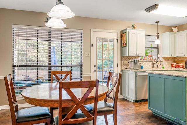 dining space featuring dark hardwood / wood-style flooring and sink