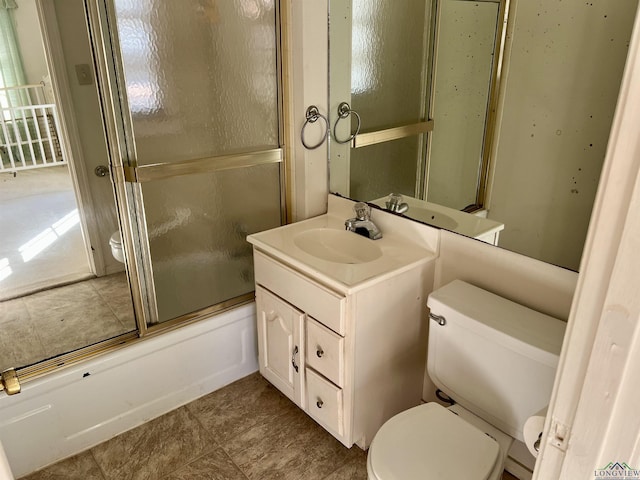 full bathroom with vanity, toilet, and combined bath / shower with glass door