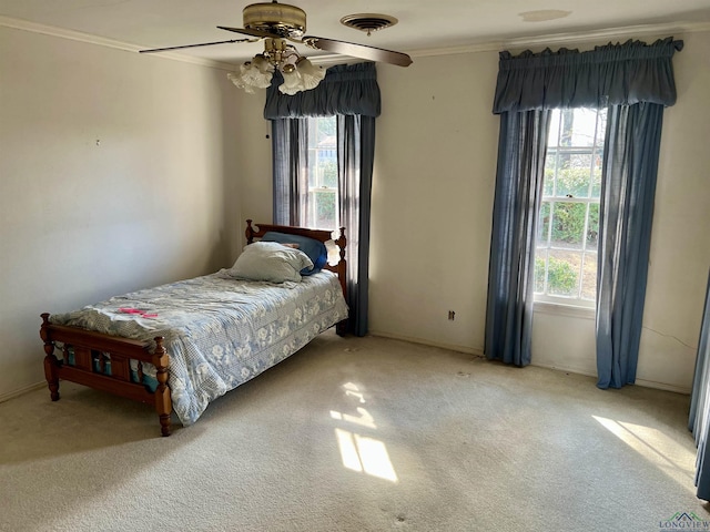 carpeted bedroom with crown molding and ceiling fan