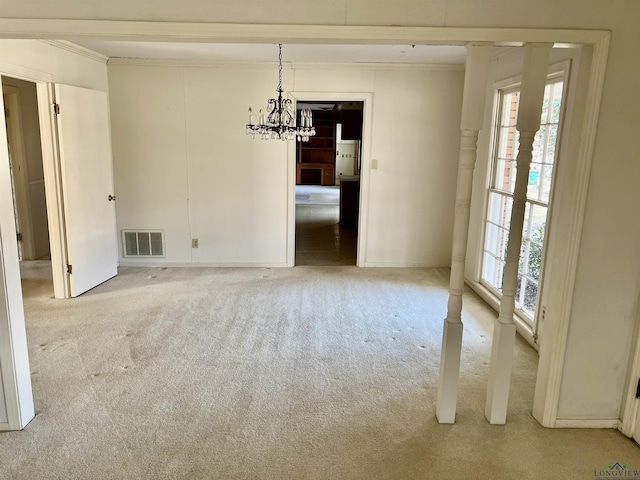 unfurnished dining area featuring crown molding, a healthy amount of sunlight, light carpet, and an inviting chandelier