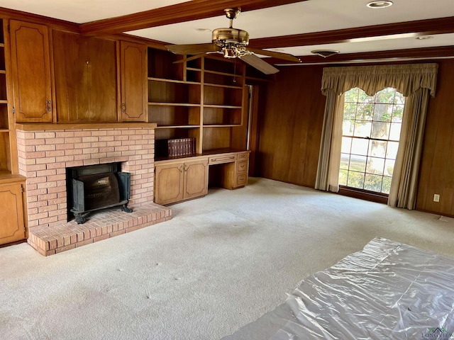 living room with light carpet, ceiling fan, beamed ceiling, and wood walls