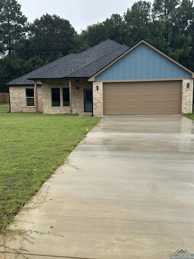 ranch-style house with a garage and a front yard