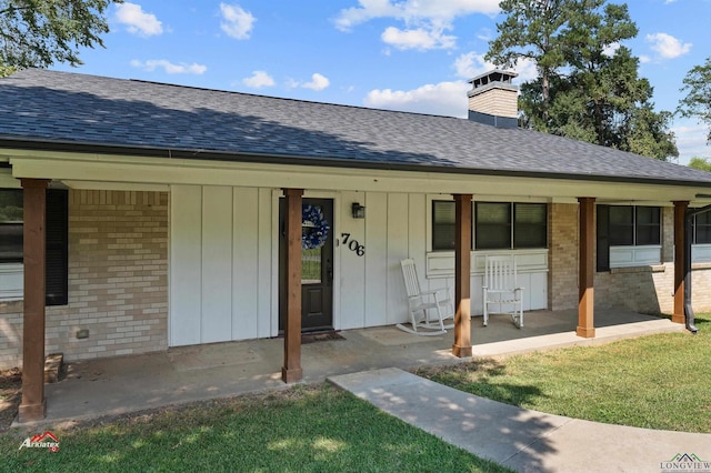 view of exterior entry with covered porch