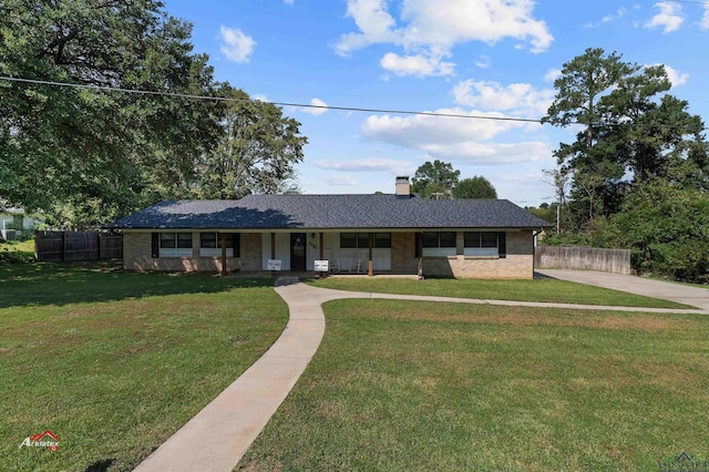 single story home with a front yard and covered porch