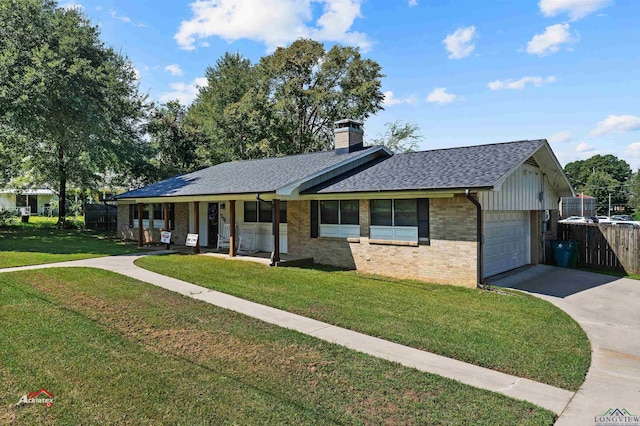 ranch-style house featuring covered porch, a front yard, and a garage