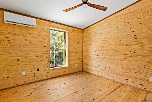 empty room with wooden walls, lofted ceiling, ceiling fan, a wall unit AC, and light hardwood / wood-style flooring