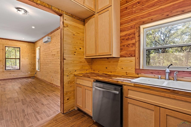 kitchen with sink, wooden counters, light brown cabinets, stainless steel dishwasher, and hardwood / wood-style flooring