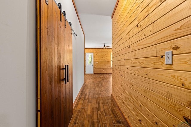 hallway featuring hardwood / wood-style floors and wooden walls