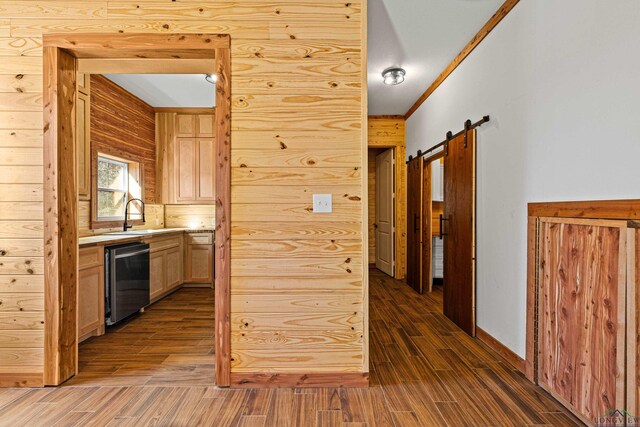 hallway featuring ornamental molding, a barn door, and sink