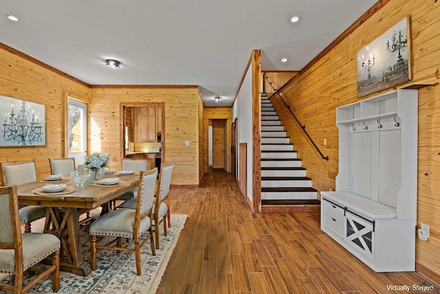 dining room with hardwood / wood-style flooring and wooden walls