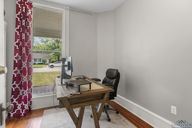 office space featuring baseboards and wood finished floors