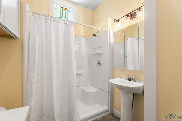 bathroom featuring a sink and curtained shower