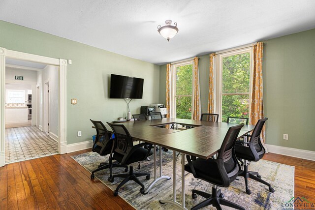 office area with baseboards, plenty of natural light, and wood finished floors