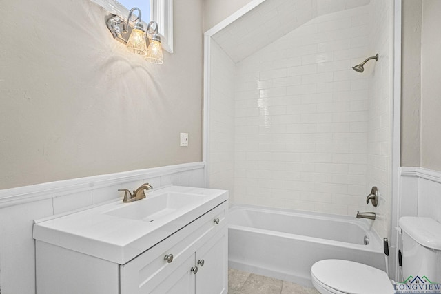 full bathroom featuring shower / bath combination, wainscoting, toilet, and vanity