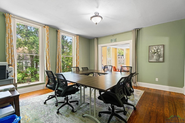 office space featuring baseboards and wood finished floors
