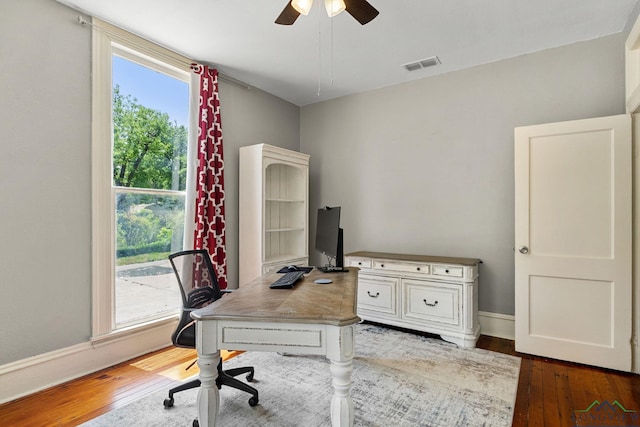 home office featuring a ceiling fan, baseboards, visible vents, and hardwood / wood-style flooring